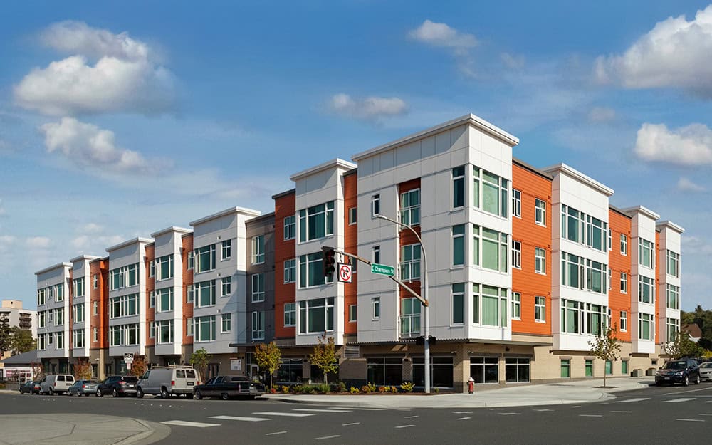 Modern Eleanor Apartments building with colorful facade and large windows.