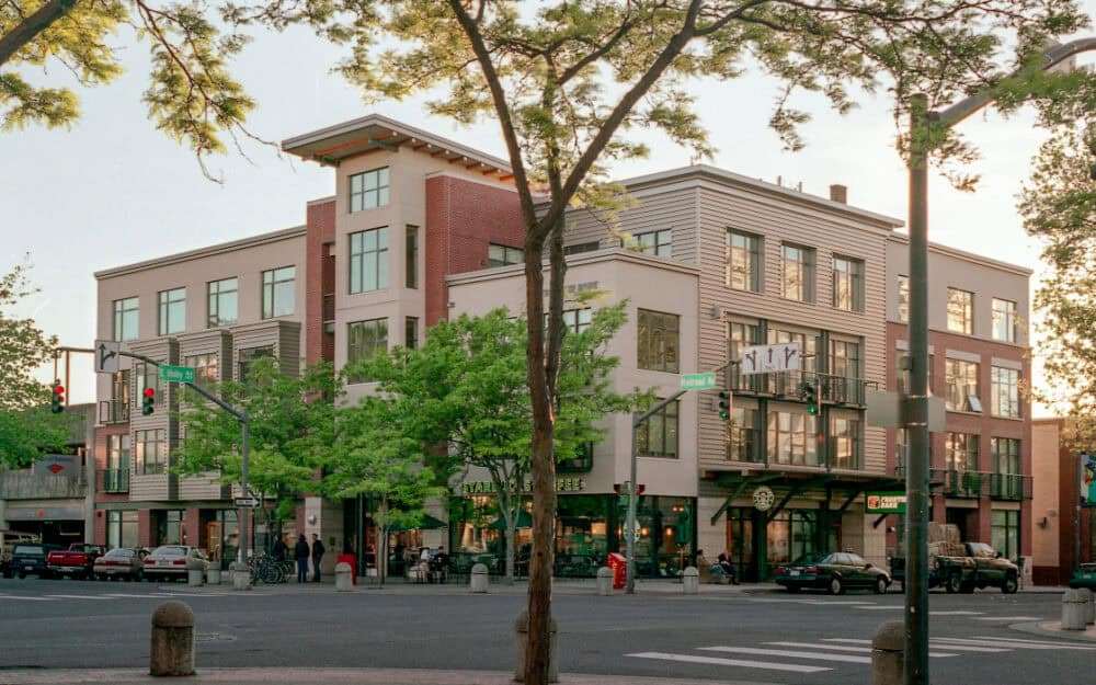 Modern mixed-use building in a vibrant urban setting.