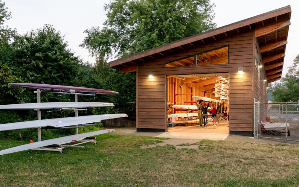 Boathouse with rowing shells at Whatcom Rowing Association, showcasing RMC Architects' design.