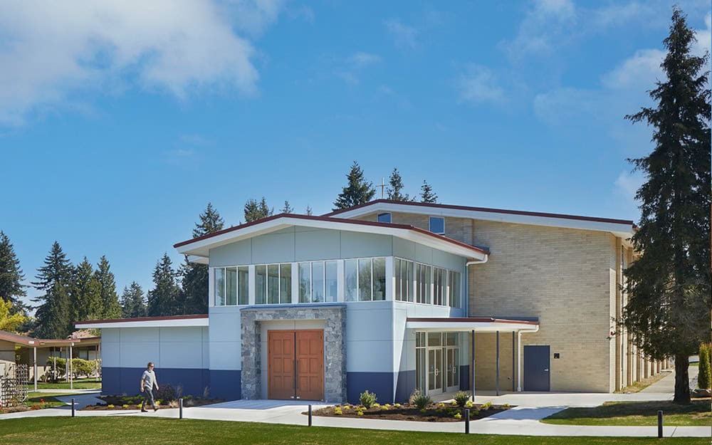 Modern church building with large glass windows and contemporary architecture.