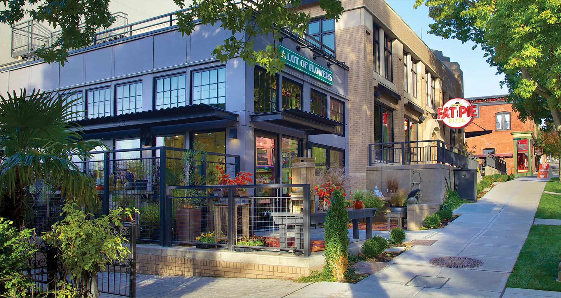 Modern urban building with outdoor patio and greenery, designed by RMC Architects.
