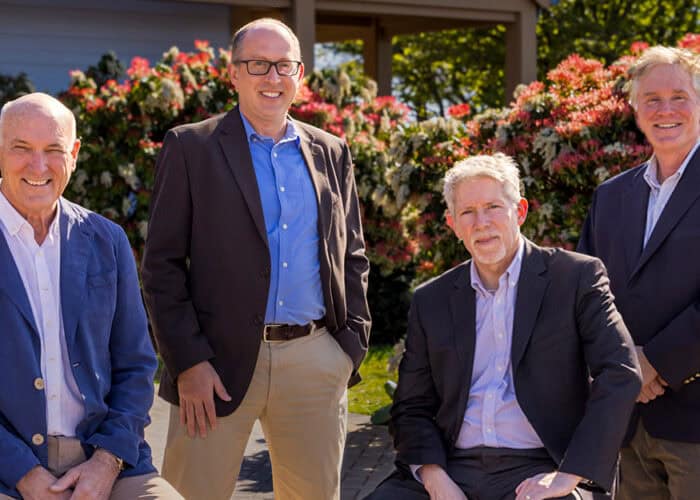 RMC Architects team members outdoors, celebrating Jeff McClure's contributions.
