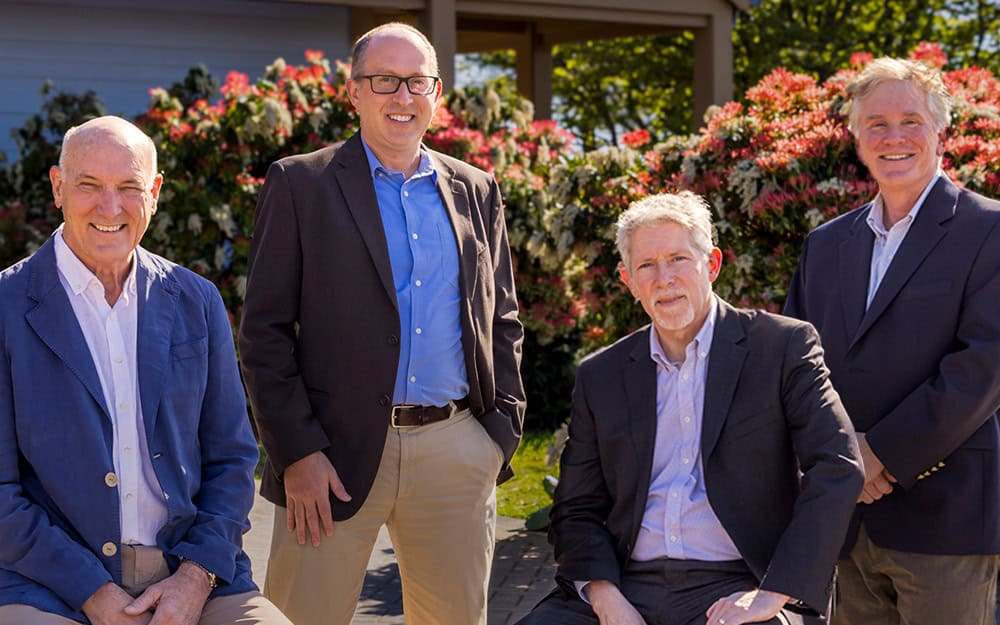 RMC Architects team members outdoors, celebrating Jeff McClure's contributions.