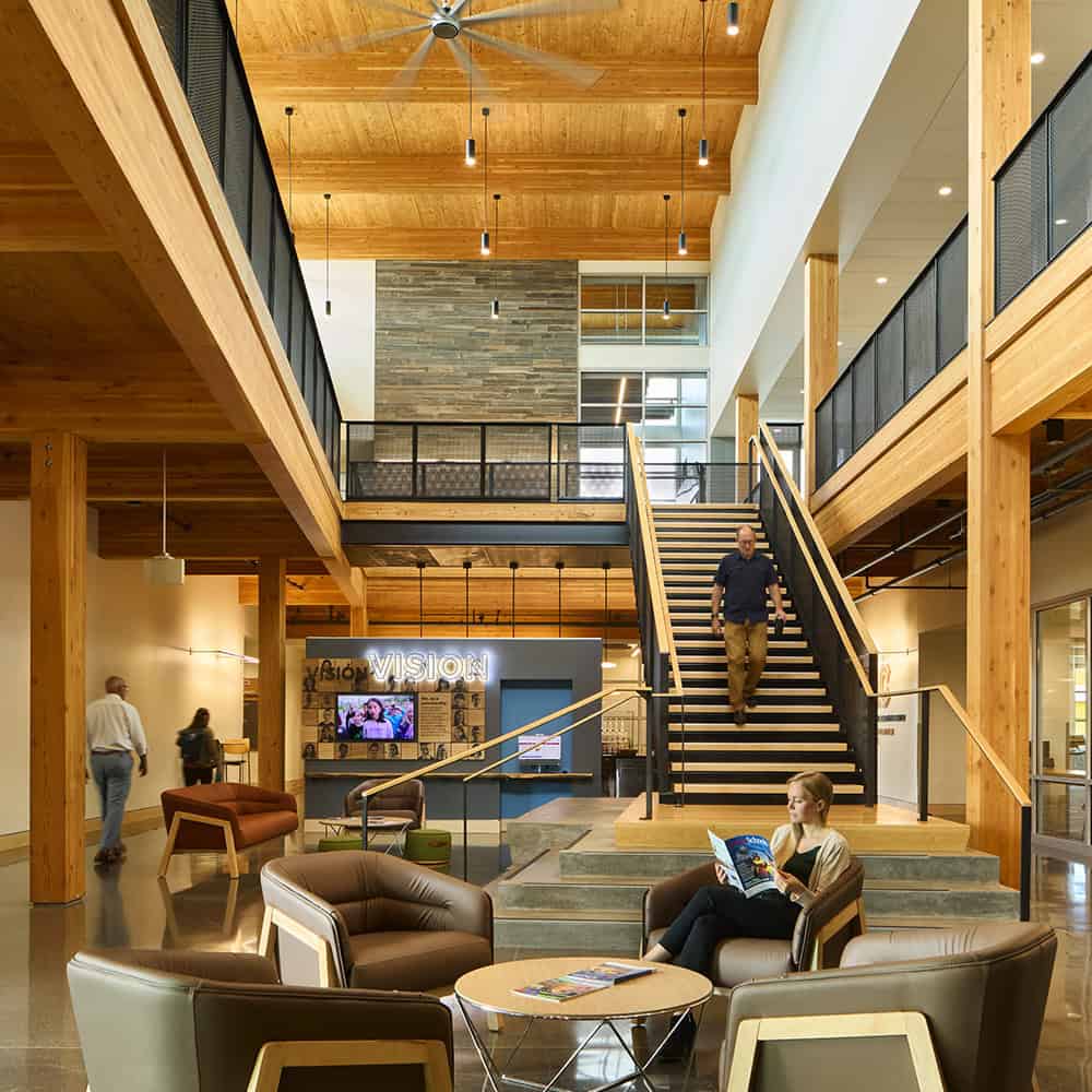 Modern architectural interior with wooden accents and seating area at RMC Architects.