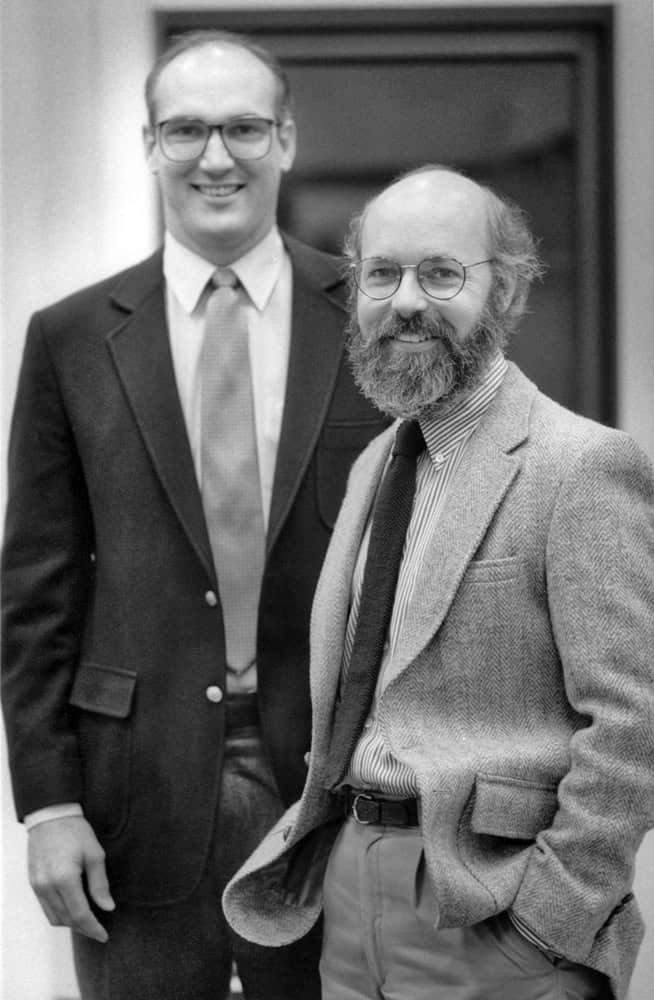 Two architects smiling at a professional event, celebrating 40 years of excellence.