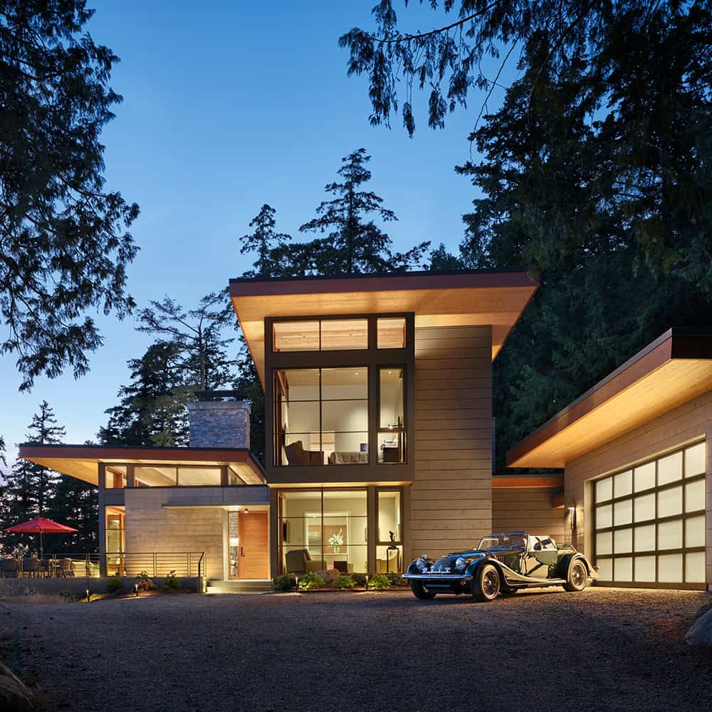Contemporary mountain home with large glass windows and modern design.