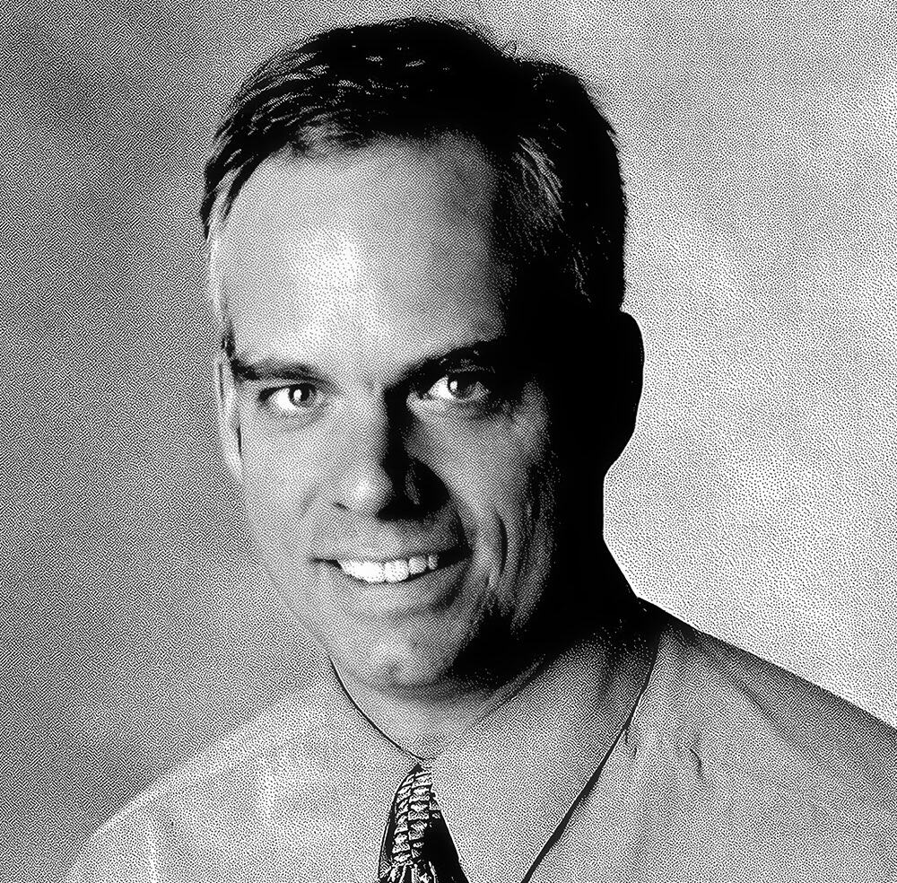 Portrait of a smiling man in professional attire for RMC Architects.