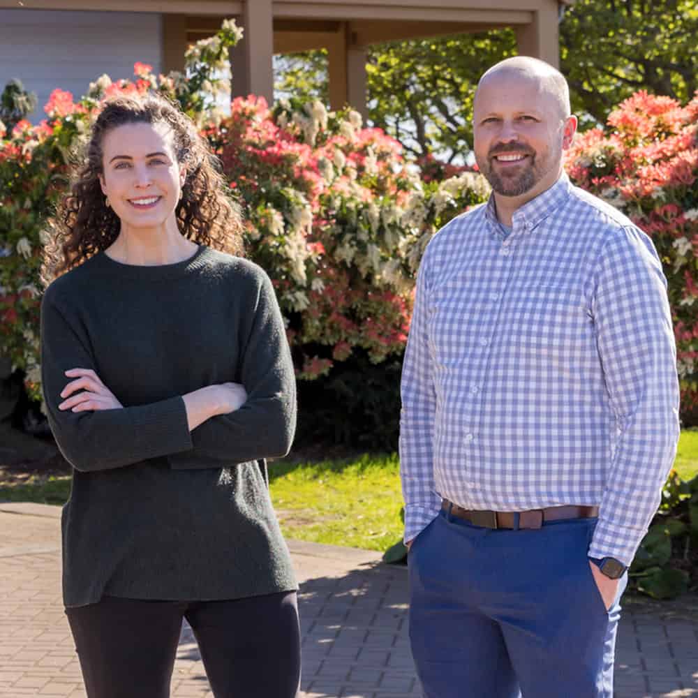 RMC Architects team outdoors with blooming flowers, celebrating 40 years of service.