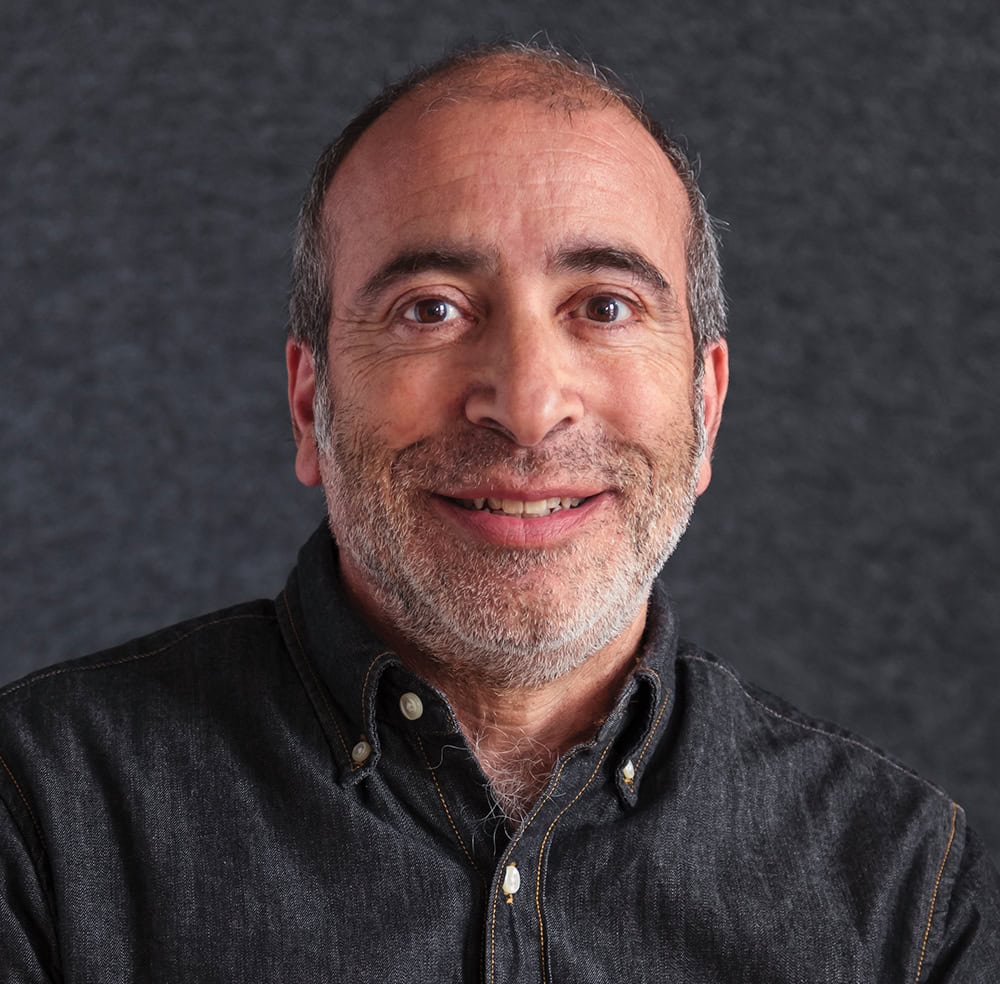 Portrait of a smiling man in a black shirt for RMC Architects.